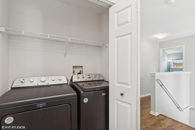 washroom with washer and clothes dryer and wood-type flooring