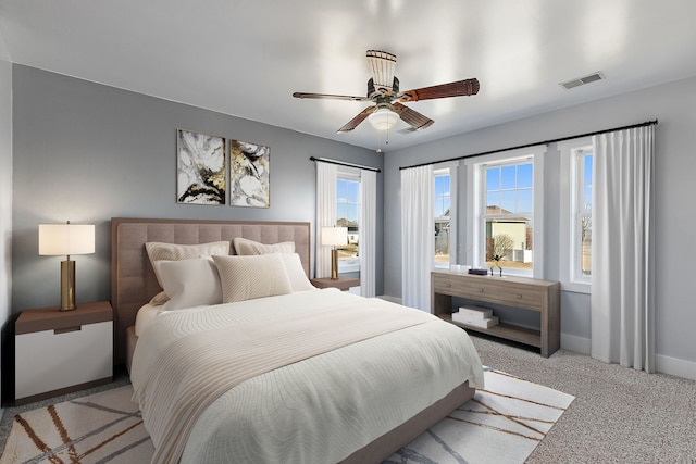 bedroom featuring light colored carpet and ceiling fan