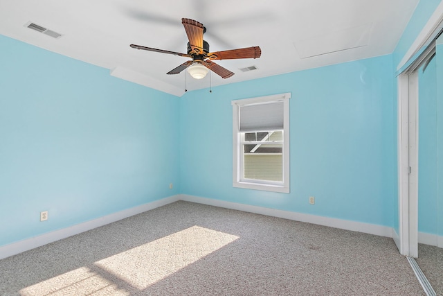 carpeted spare room with ceiling fan