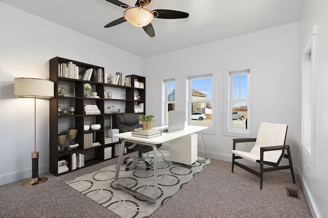 carpeted office space with ceiling fan