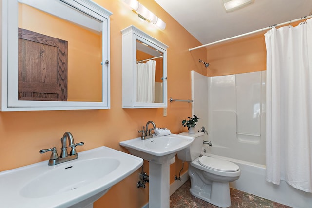 bathroom featuring double sink, toilet, and shower / bath combo