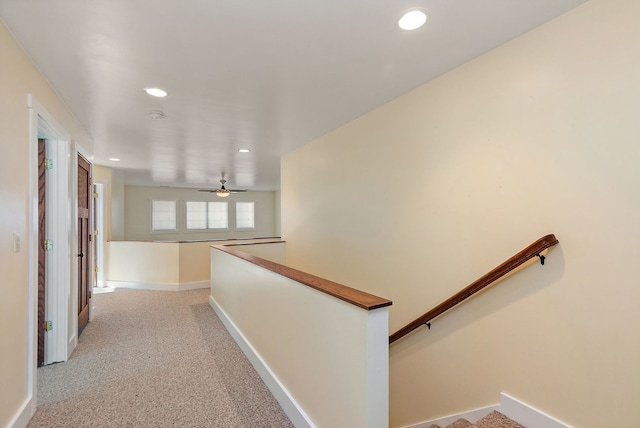 corridor featuring light colored carpet