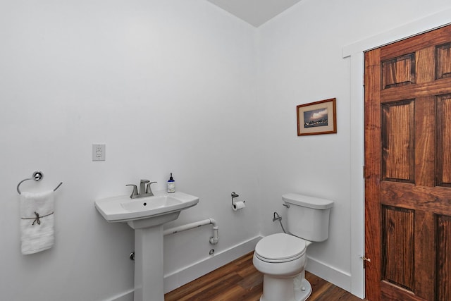 bathroom with wood-type flooring and toilet