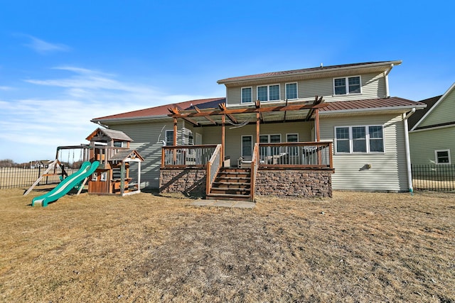 rear view of property with a playground and a lawn