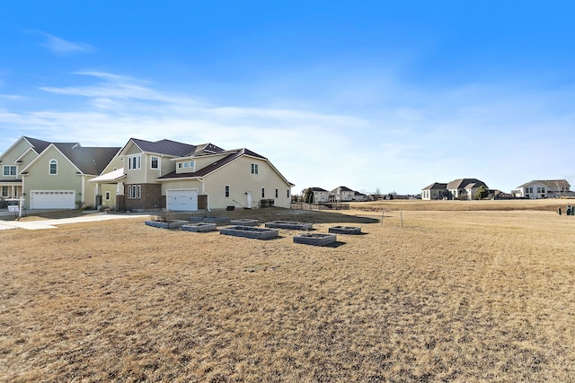 view of home's exterior with a garage and a lawn