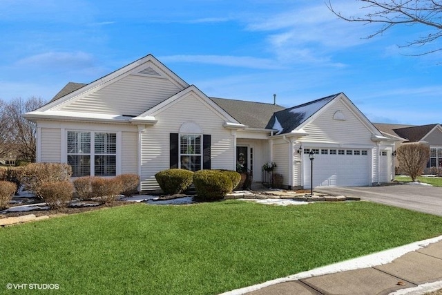 view of front of house with a garage and a front yard