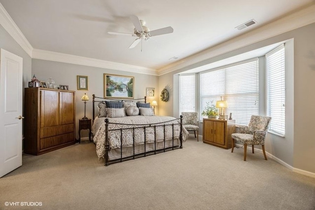 carpeted bedroom with crown molding and ceiling fan