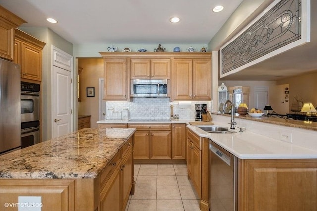 kitchen featuring a kitchen island, appliances with stainless steel finishes, sink, light tile patterned floors, and kitchen peninsula