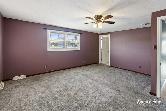 unfurnished bedroom with a textured ceiling, ceiling fan, and carpet