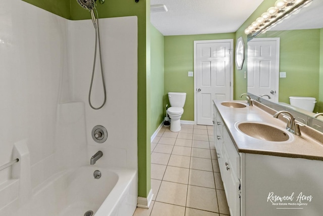 full bathroom featuring toilet, washtub / shower combination, tile patterned flooring, a textured ceiling, and vanity