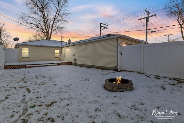 snow covered property featuring a fire pit