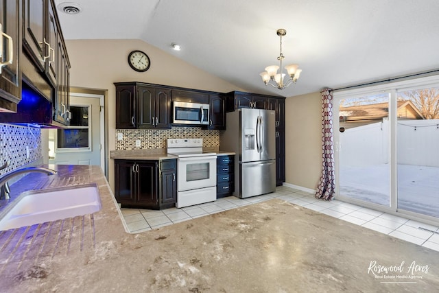 kitchen with light tile patterned floors, appliances with stainless steel finishes, dark brown cabinetry, and sink