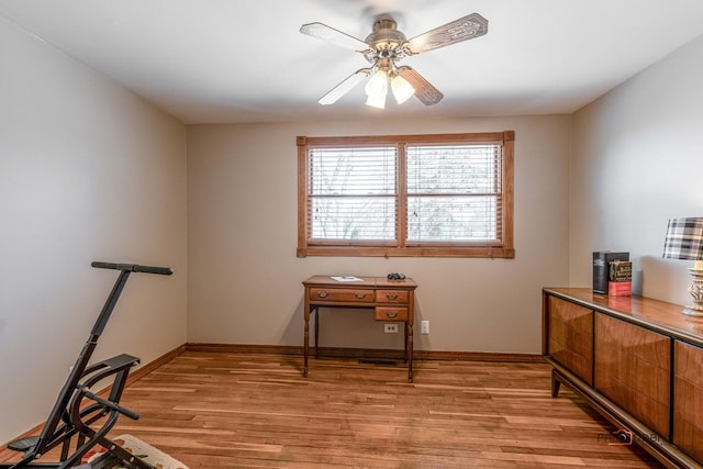 interior space with ceiling fan, light wood-style flooring, and baseboards