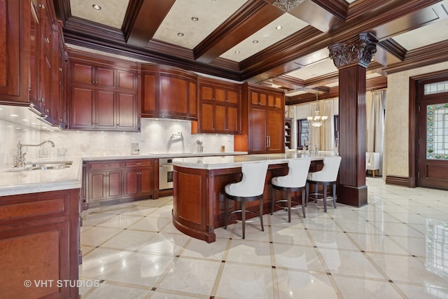 915 N Dearborn St, Chicago, IL 60610 - kitchen featuring a sink, light countertops, reddish brown cabinets, and oven