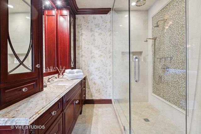 915 N Dearborn St, Chicago, IL 60610 - full bathroom with baseboards, crown molding, vanity, wallpapered walls, and a stall shower