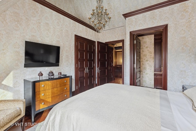 915 N Dearborn St, Chicago, IL 60610 - bedroom featuring wallpapered walls, wood finished floors, and a notable chandelier