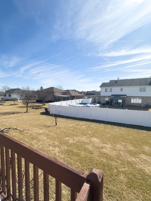 view of yard featuring a residential view and fence