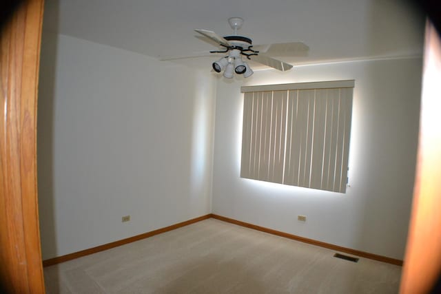 carpeted empty room with ceiling fan