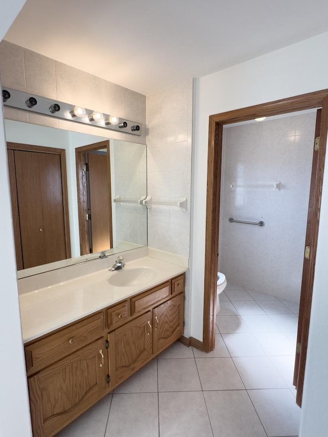 bathroom with vanity, toilet, and tile patterned floors