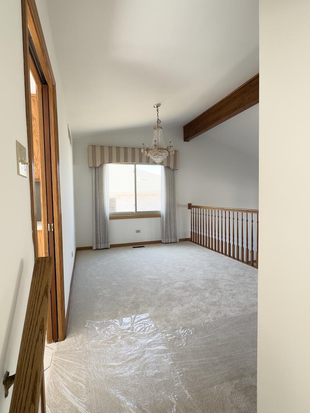 unfurnished room featuring vaulted ceiling with beams, carpet floors, baseboards, and an inviting chandelier