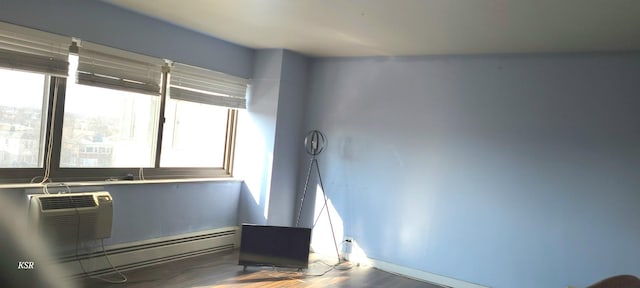 interior space featuring a wall mounted AC, parquet flooring, and a baseboard radiator