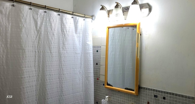 bathroom with tile walls