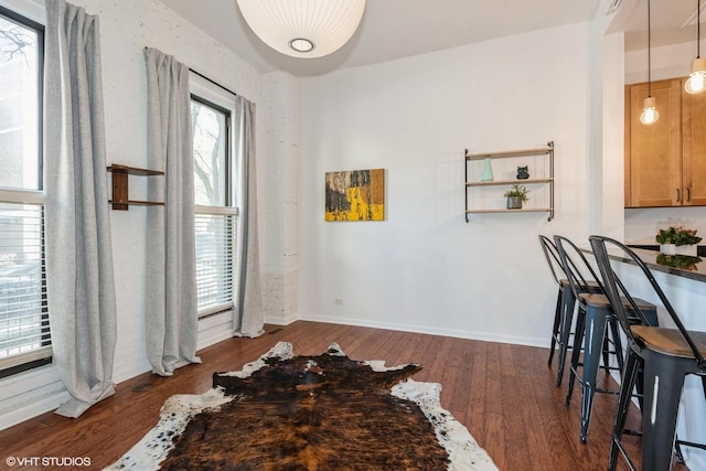 dining space with dark hardwood / wood-style flooring