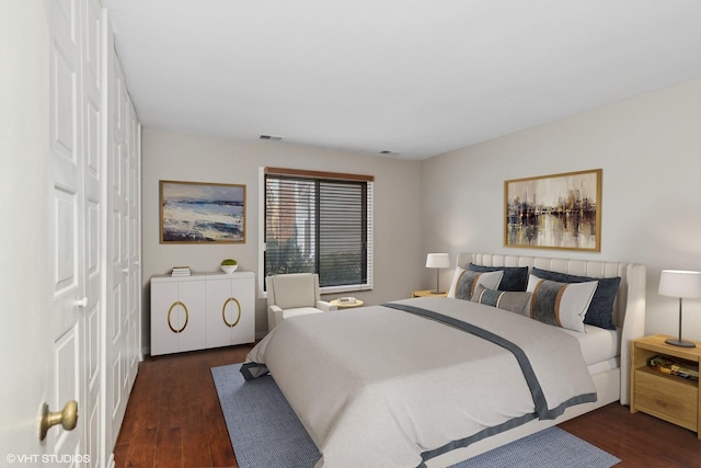 bedroom with dark wood-type flooring