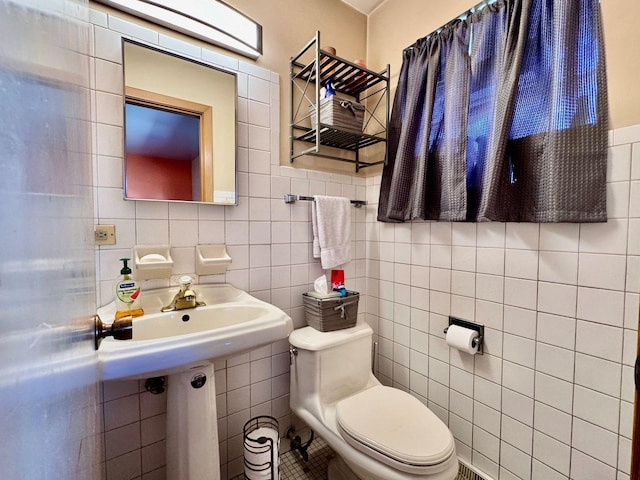 bathroom with backsplash, tile walls, and toilet