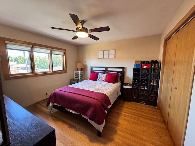 bedroom with ceiling fan, a closet, and light hardwood / wood-style flooring