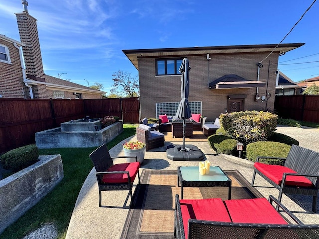 back of house with an outdoor living space and a patio area