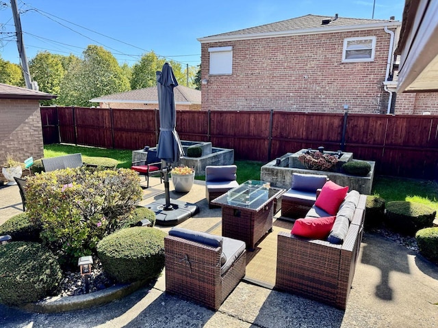 view of patio with an outdoor living space with a fire pit