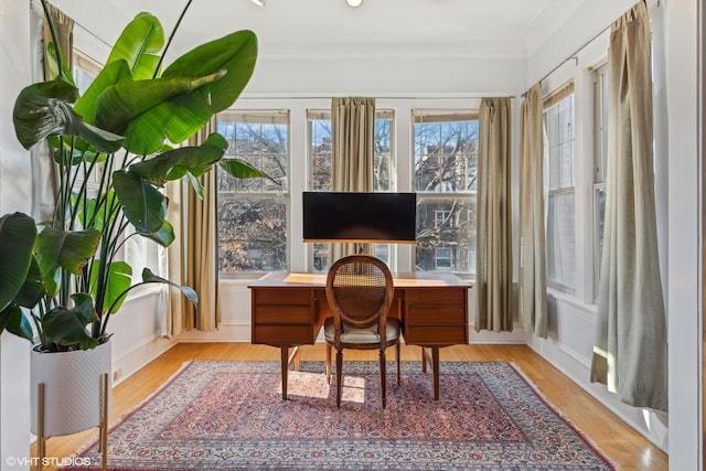 home office featuring crown molding and light wood-type flooring