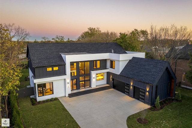 contemporary house with a garage and a yard