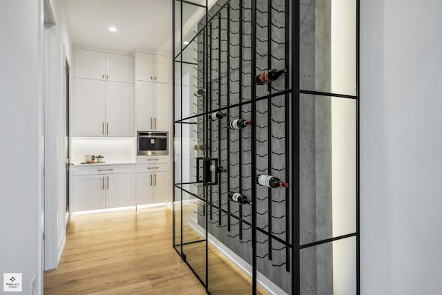 wine area with light wood-type flooring