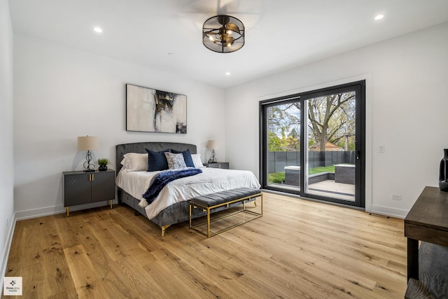 bedroom featuring light hardwood / wood-style floors and access to outside