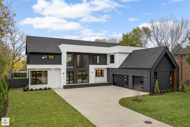 view of front of home with a front lawn and a garage