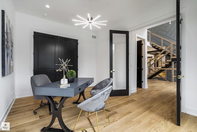 dining room with a chandelier and light hardwood / wood-style flooring