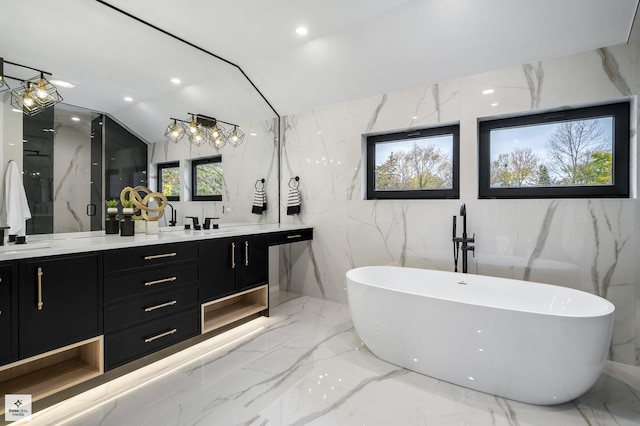 bathroom featuring shower with separate bathtub, vanity, and vaulted ceiling