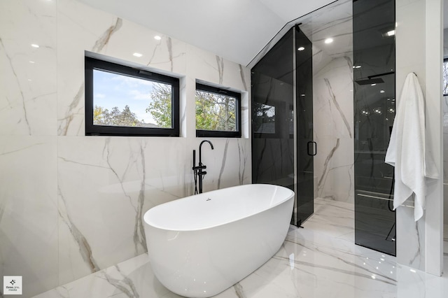 bathroom featuring shower with separate bathtub