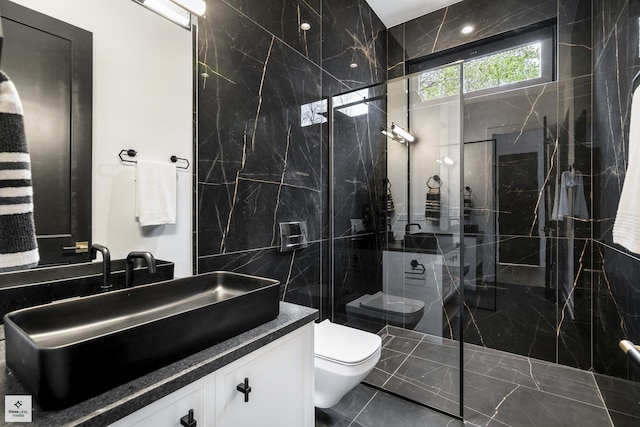 bathroom featuring toilet, vanity, and a tile shower