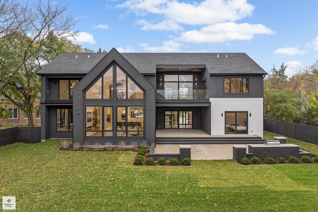 rear view of property featuring a patio area and a yard