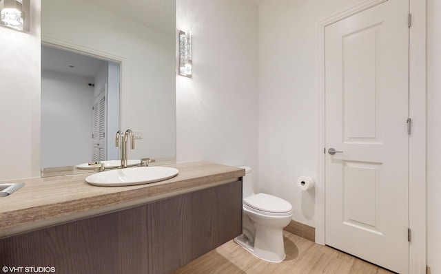 bathroom featuring hardwood / wood-style floors, toilet, and vanity