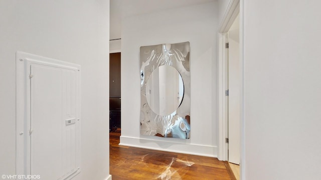 hallway with hardwood / wood-style flooring