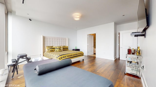 bedroom featuring dark hardwood / wood-style flooring