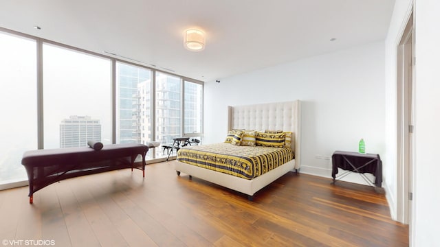 bedroom featuring dark hardwood / wood-style flooring and floor to ceiling windows