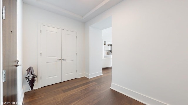 hallway with dark wood-type flooring