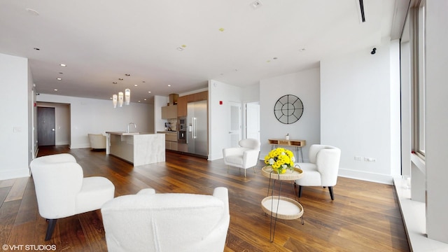 living room with dark wood-type flooring and sink