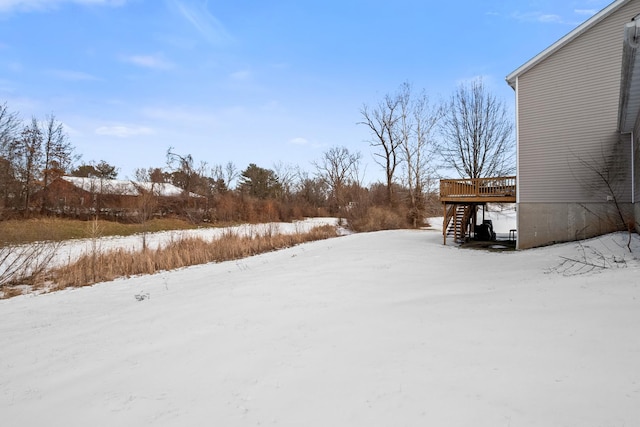 yard layered in snow featuring a wooden deck