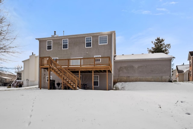 snow covered property with a wooden deck